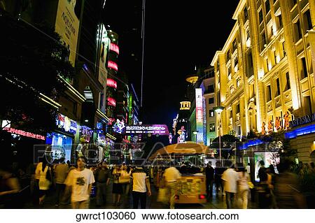 Group of people walking in a street at night, Nanjing Road, Shanghai, China View Large Photo Image Stock Image - Group of people walking in a street at night, Nanjing Road, Shanghai, China. Fotosearch