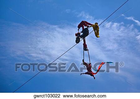 Low angle view of three people performing stunt on a rope, Emerald Valley, Huangshan, Anhui Province, China View Large Photo Image Stock Image - Low angle view of three people performing stunt on a rope, Emerald Valley, Huangshan, Anhui Province, China. Fotosearch