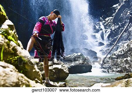 Mature woman holding her wet hair, Jinkeng Terraced Field, Guangxi Province, China View Large Photo Image Stock Photo - Mature woman holding her wet hair, Jinkeng Terraced Field, Guangxi Province, China. Fotosearch