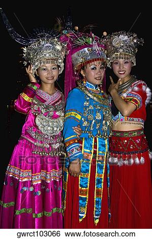 Stock Photograph - Portrait of two young women and a teenage girl smiling, Guilin, Guangxi Province, China. Fotosearch