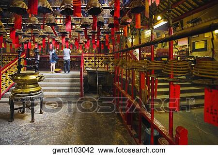 Rear view of a man and a woman praying in a temple, Man Mo Temple, Hong Kong, China View Large Photo Image Stock Image - Rear view of a man and a woman praying in a temple, Man Mo Temple, Hong Kong, China. Fotosearch