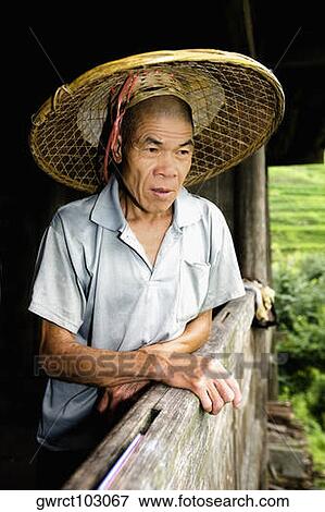 Senior man leaning against a wall, Jinkeng Terraced Field, Guangxi Province, China View Large Photo Image Stock Photo - Senior man leaning against a wall, Jinkeng Terraced Field, Guangxi Province, China. Fotosearch