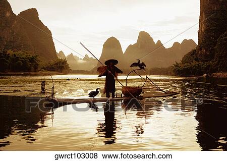Silhouette of a fisherman fishing in a river with a hill range in the background, Guilin Hills, XingPing, Yangshuo, Guangxi Province, China View Large Photo Image Stock Photo - Silhouette of a fisherman fishing in a river with a hill range in the background, Guilin Hills, XingPing, Yangshuo, Guangxi Province, China. Fotosearch