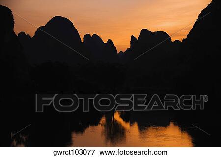 Silhouette of hills at dusk, Guilin Hills, Li River, Yangshuo, Guangxi Province, China View Large Photo Image Stock Photo - Silhouette of hills at dusk, Guilin Hills, Li River, Yangshuo, Guangxi Province, China. Fotosearch