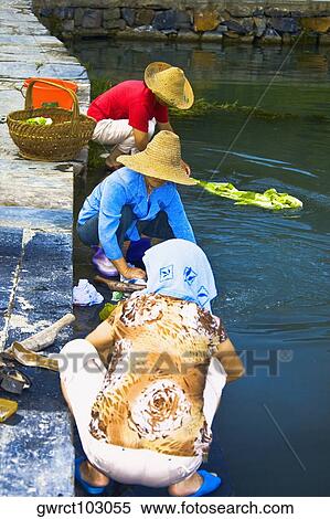 Three women washing clothes at riverbank, Xidi, Anhui Province, China View Large Photo Image Stock Photography - Three women washing clothes at riverbank, Xidi, Anhui Province, China. Fotosearch