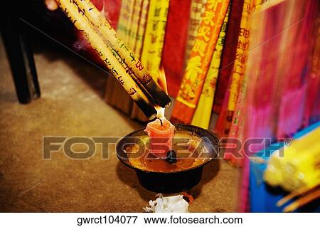Incenses being ignited with a candle, Da Zhao Temple, Hohhot, Inner Mongolia, China View Large Photo Image Stock Photo - Incenses being ignited with a candle, Da Zhao Temple, Hohhot, Inner Mongolia, China. Fotosearch