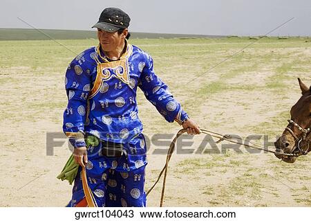 Young man in traditional clothing with a horse, Inner Mongolia, China View Large Photo Image Stock Image - Young man in traditional clothing with a horse, Inner Mongolia, China. Fotosearch