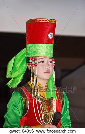 Young woman holding a microphone and singing, Inner Mongolia, China View Large Photo Image Stock Photograph - Young woman holding a microphone and singing, Inner Mongolia, China. Fotosearch