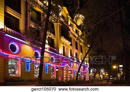 Stock Image - Building lit up at night, Shamian Island, Guangzhou, Guangdong Province, China. Fotosearch
