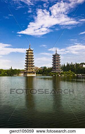 Pagodas at lakeside, Sun And Moon Pagoda, Banyan Lake, Guilin, Guangxi Province, China View Large Photo Image Stock Photo - Pagodas at lakeside, Sun And Moon Pagoda, Banyan Lake, Guilin, Guangxi Province, China. Fotosearch