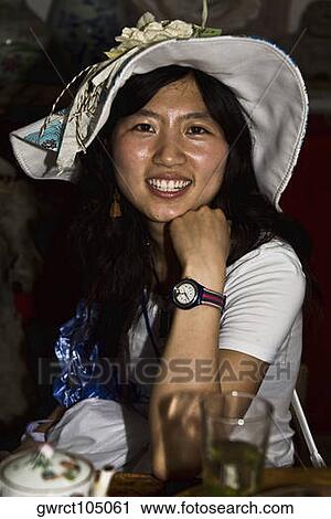 Portrait of a young woman sitting in a cafe and smiling, Xidi, Anhui Province, China View Large Photo Image Stock Image - Portrait of a young woman sitting in a cafe and smiling, Xidi, Anhui Province, China. Fotosearch