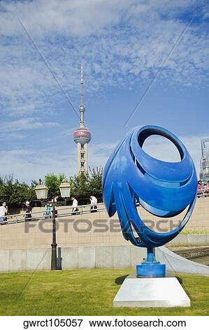 Stock Photo - Sculpture in front of a tower, Oriental Pearl Tower, Shanghai, China. Fotosearch