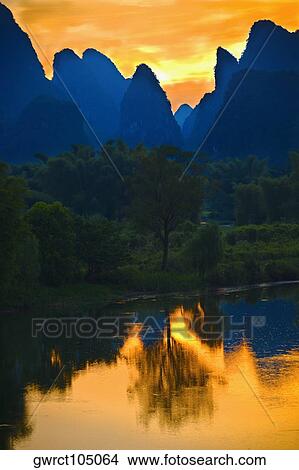 Silhouette of hills at dawn, Guilin Hills, Li River, Yangshuo, Guangxi Province, China View Large Photo Image Picture - Silhouette of hills at dawn, Guilin Hills, Li River, Yangshuo, Guangxi Province, China. Fotosearch