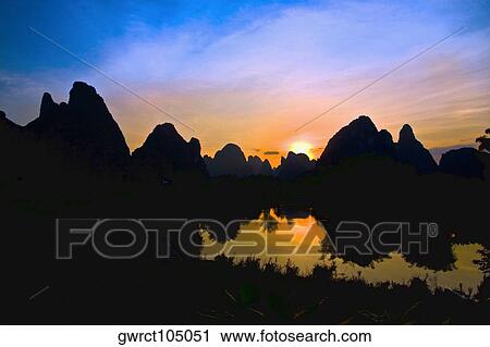 Silhouette of hills at dawn, Guilin Hills, Li River, Yangshuo, Guangxi Province, China View Large Photo Image Stock Image - Silhouette of hills at dawn, Guilin Hills, Li River, Yangshuo, Guangxi Province, China. Fotosearch