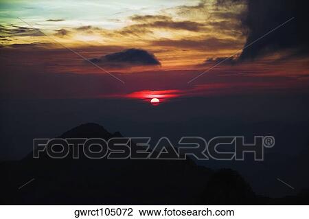 Stock Image - Silhouette of mountains at dusk, Huangshan Mountains, Anhui Province, China. Fotosearch