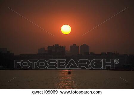 Sunset over a city, Shamian Island, Guangzhou, Guangdong Province, China View Large Photo Image Stock Photo - Sunset over a city, Shamian Island, Guangzhou, Guangdong Province, China. Fotosearch