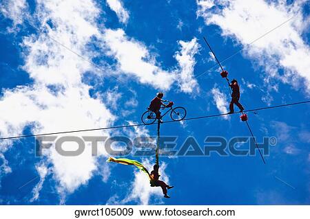 Three performers performing stunt on a rope, Emerald Valley, Huangshan, Anhui Province, China View Large Photo Image Stock Photo - Three performers performing stunt on a rope, Emerald Valley, Huangshan, Anhui Province, China. Fotosearch