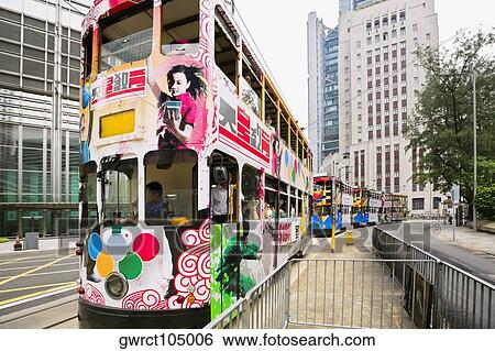 Stock Photograph - Trams moving on the track, Des Voeux Road, Hong Kong Island, China. Fotosearch