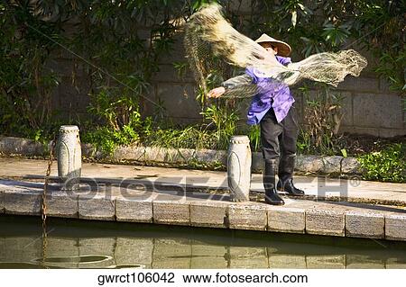 Fisherman throwing a fishing net in a lake, Guilin, Guangxi Province, China View Large Photo Image Stock Image - Fisherman throwing a fishing net in a lake, Guilin, Guangxi Province, China. Fotosearch