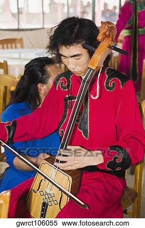 Mid adult man playing a Morin khuur, Inner Mongolia, China View Large Photo Image Stock Photography - Mid adult man playing a Morin khuur, Inner Mongolia, China. Fotosearch