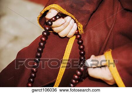 Mid section view of a person's hand holding a prayer beads, Da Zhao Temple, Hohhot, Inner Mongolia, China View Large Photo Image Stock Photograph - Mid section view of a person's hand holding a prayer beads, Da Zhao Temple, Hohhot, Inner Mongolia, China. Fotosearch