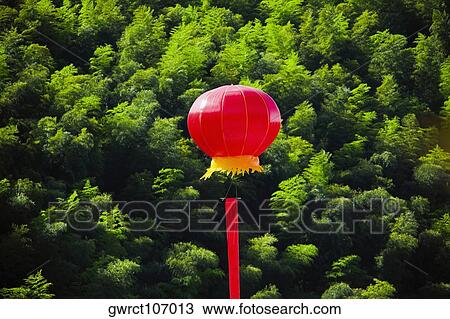 Stock Image - Chinese lantern over trees, Emerald Valley, Huangshan, Anhui Province, China. Fotosearch