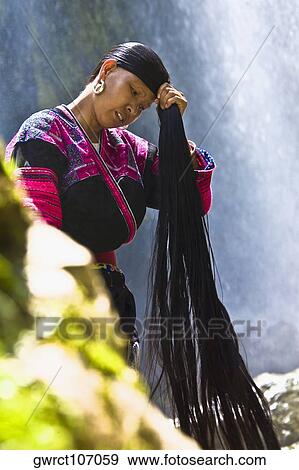 Mature woman holding her wet hair, Jinkeng Terraced Field, Guangxi Province, China View Large Photo Image Stock Photo - Mature woman holding her wet hair, Jinkeng Terraced Field, Guangxi Province, China. Fotosearch