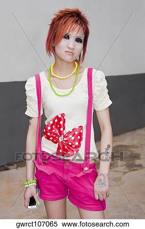 Portrait of a young woman standing, Zhengzhou, Henan Province, China View Large Photo Image Stock Photography - Portrait of a young woman standing, Zhengzhou, Henan Province, China. Fotosearch