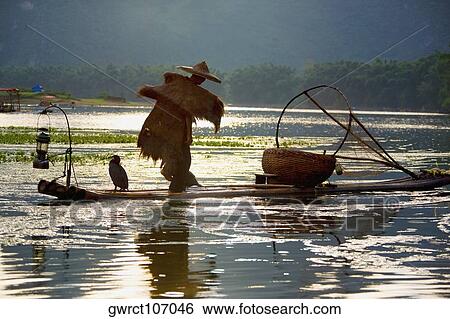 Rear view of a fisherman fishing in a river, XingPing, Yangshuo, Guangxi Province, China View Large Photo Image Stock Photograph - Rear view of a fisherman fishing in a river, XingPing, Yangshuo, Guangxi Province, China. Fotosearch