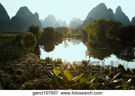 Reflection of trees in water, Guilin Hills, Xingping, Yangshuo, Guangxi Province, China View Large Photo Image Stock Photo - Reflection of trees in water, Guilin Hills, Xingping, Yangshuo, Guangxi Province, China. Fotosearch