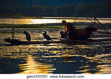 Silhouette of a senior man sitting in a wooden raft, Li River, XingPing, Yangshuo, Guangxi Province, China View Large Photo Image Stock Image - Silhouette of a senior man sitting in a wooden raft, Li River, XingPing, Yangshuo, Guangxi Province, China. Fotosearch