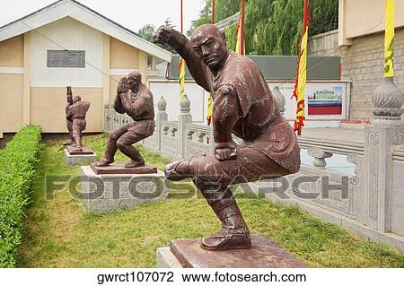 Stock Image - Statues of monks in fighting stances, Shaolin Monastery, Henan Province, China. Fotosearch
