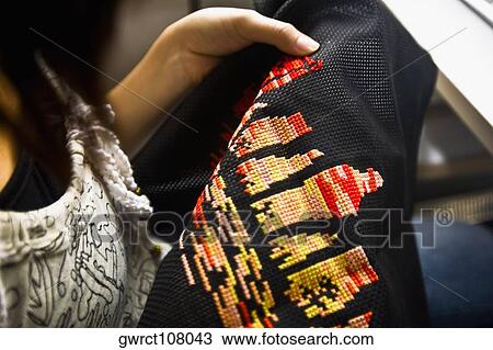 Close-up of a woman embroidering, Shandong Province, China View Large Photo Image Stock Image - Close-up of a woman embroidering, Shandong Province, China. Fotosearch