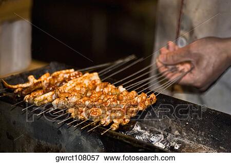 Person's hand roasting seafood, Nanjing, Jiangsu Province, China View Large Photo Image Stock Photo - Person's hand roasting seafood, Nanjing, Jiangsu Province, China. Fotosearch