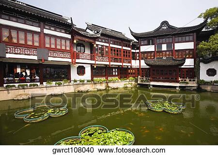 Stock Image - Pond in front of a building, Yu Yuan Gardens, Shanghai, China. Fotosearch