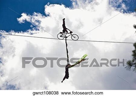 Silhouette of two performers performing stunt on a rope, Emerald Valley, Huangshan, Anhui Province, China View Large Photo Image Stock Photo - Silhouette of two performers performing stunt on a rope, Emerald Valley, Huangshan, Anhui Province, China. Fotosearch