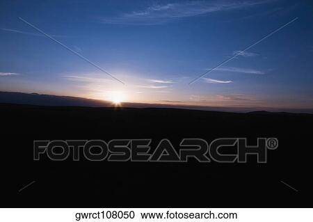 Stock Image - Sunrise over a landscape, Inner Mongolia, China. Fotosearch