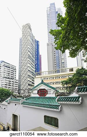 Temple with skyscrapers in the background, Man Mo Temple, Hong Kong, China View Large Photo Image Picture - Temple with skyscrapers in the background, Man Mo Temple, Hong Kong, China. Fotosearch