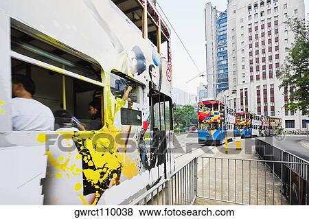 Stock Photo - Trams moving on the track, Des Voeux Road, Hong Kong Island, China. Fotosearch