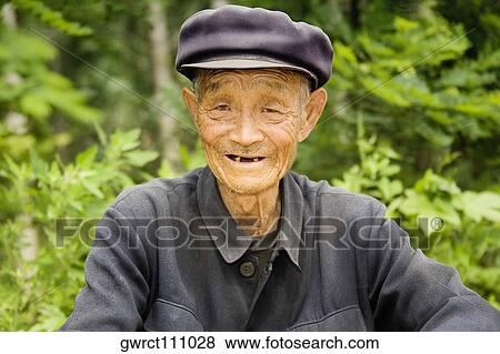 Stock Photo - Portrait of a senior man smiling, Zhigou, Shandong Province, China. Fotosearch