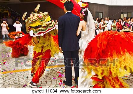 Picture - Rear view of a newlywed couple in a traditional ceremony, Qingdao, Shandong Province, China. Fotosearch