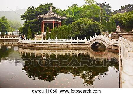 Reflection of bridge and trees in water, Zhanshan Temple, Qingdao, Shandong Province, China View Large Photo Image Stock Image - Reflection of bridge and trees in water, Zhanshan Temple, Qingdao, Shandong Province, China. Fotosearch