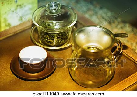 Teapot with a tea cup and a jar on a table, Qingdao, Shandong Province, China View Large Photo Image Stock Photo - Teapot with a tea cup and a jar on a table, Qingdao, Shandong Province, China. Fotosearch