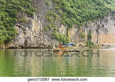 Boats in a river, XingPing, Yangshuo, Guangxi Province, China View Large Photo Image Stock Photo - Boats in a river, XingPing, Yangshuo, Guangxi Province, China. Fotosearch