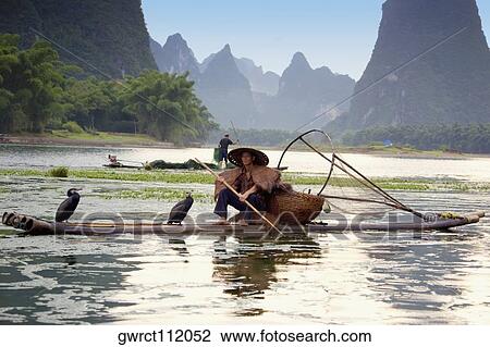 Fisherman fishing in a river with a hill range in the background, Guilin Hills, XingPing, Yangshuo, Guangxi Province, China View Large Photo Image Stock Image - Fisherman fishing in a river with a hill range in the background, Guilin Hills, XingPing, Yangshuo, Guangxi Province, China. Fotosearch