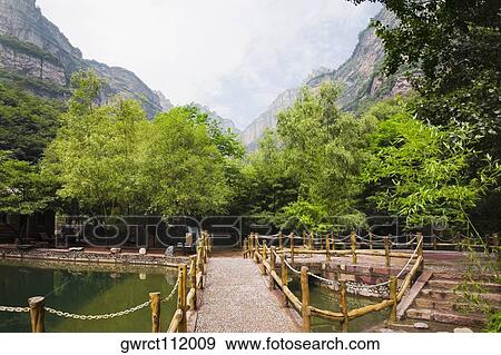 Stock Photo - Footbridge over a pond, Taihang Grand Canyon, Linzhou, Henan Province, China. Fotosearch