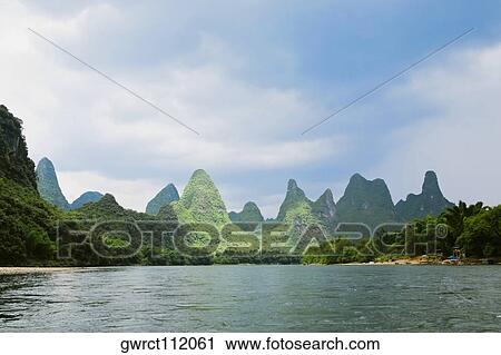 Hills along a river, Guilin Hills, XingPing, Yangshuo, Guangxi Province, China View Large Photo Image Stock Image - Hills along a river, Guilin Hills, XingPing, Yangshuo, Guangxi Province, China. Fotosearch