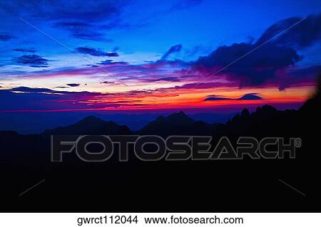 Picture - Silhouette of a mountain range at dusk, Huangshan Mountains, Anhui Province, China. Fotosearch