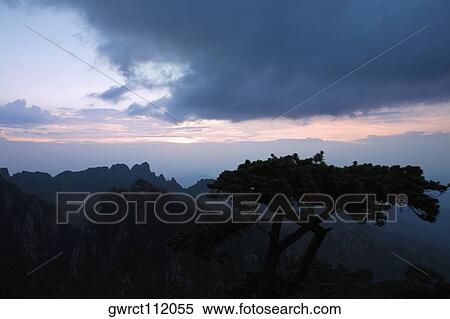 Silhouette of a mountain range at dusk, Huangshan Mountains, Anhui Province, China View Large Photo Image Stock Photography - Silhouette of a mountain range at dusk, Huangshan Mountains, Anhui Province, China. Fotosearch