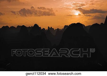Silhouette of hill ranges at dusk, Guilin Hills, Xingping, Yangshuo, Guangxi Province, China View Large Photo Image Picture - Silhouette of hill ranges at dusk, Guilin Hills, Xingping, Yangshuo, Guangxi Province, China. Fotosearch